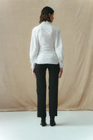 White corset-panelled shirt by Sean Sheila, shown from the back, featuring structured design and fitted silhouette.