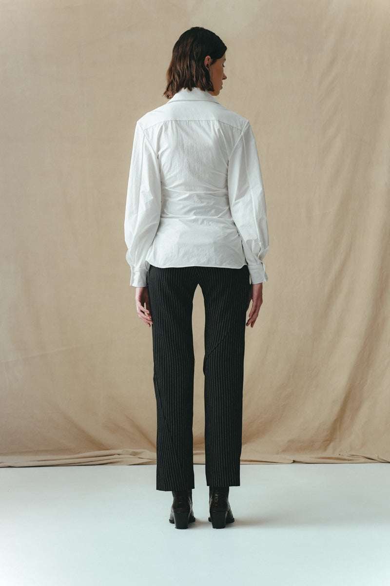 White corset-panelled shirt by Sean Sheila, shown from the back, featuring structured design and fitted silhouette.