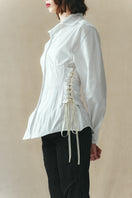 White corset-panelled shirt by Sean Sheila, featuring structured design and detailed stitching, perfect for stylish everyday wear.