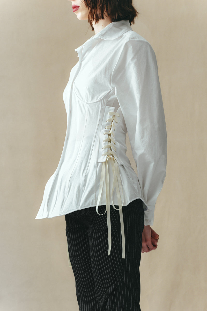 White corset-panelled shirt by Sean Sheila, featuring structured design and detailed stitching, perfect for stylish everyday wear.