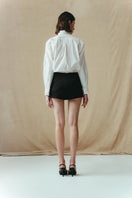 Black Sean Sheila mini skort, stylish shorts with a sleek design, shown from the back view.