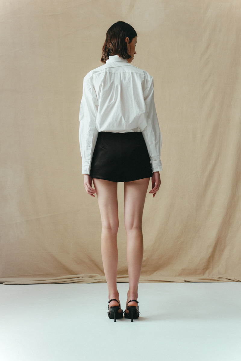 Black Sean Sheila mini skort, stylish shorts with a sleek design, shown from the back view.