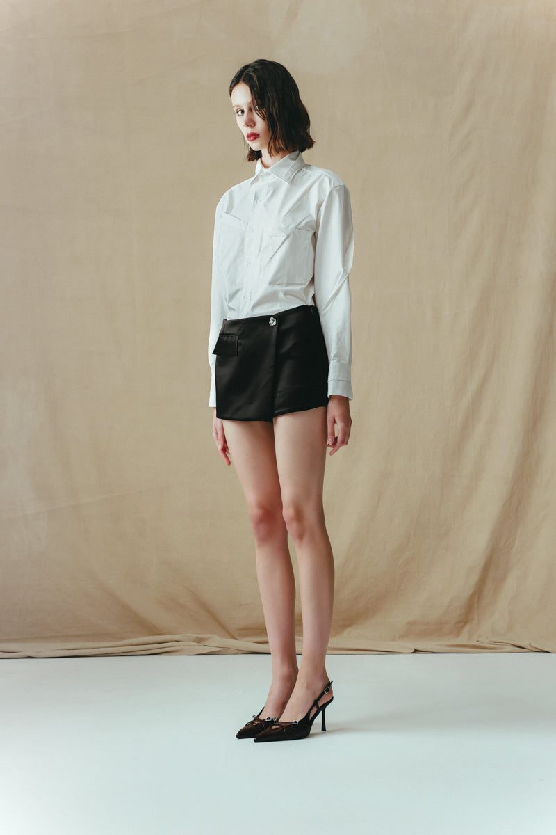 Black Sean Sheila mini skort, stylish shorts with a sleek design, displayed from a side view.