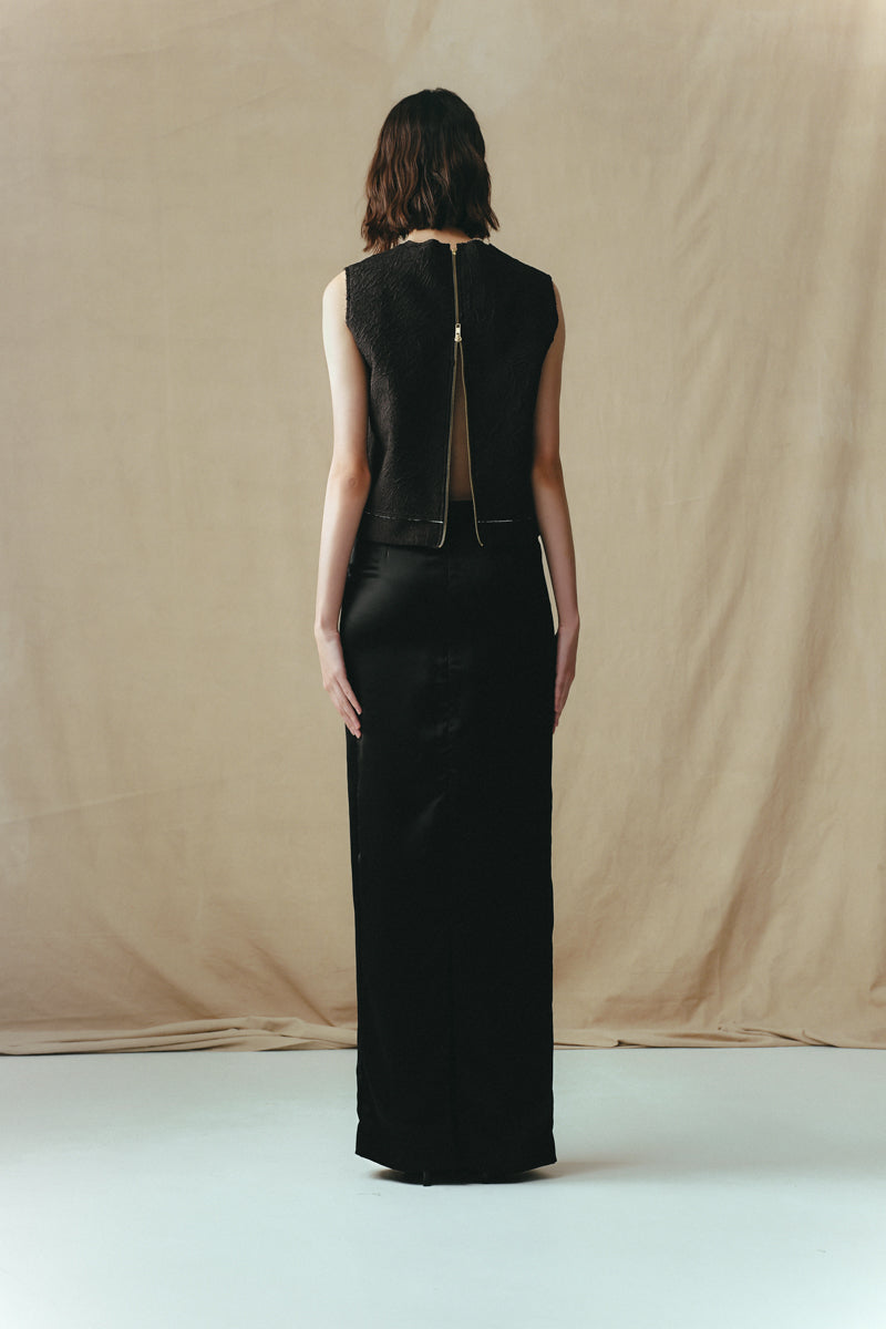 Black crinkled top by Sean Sheila, shown from the back, featuring textured fabric and stylish casual design.