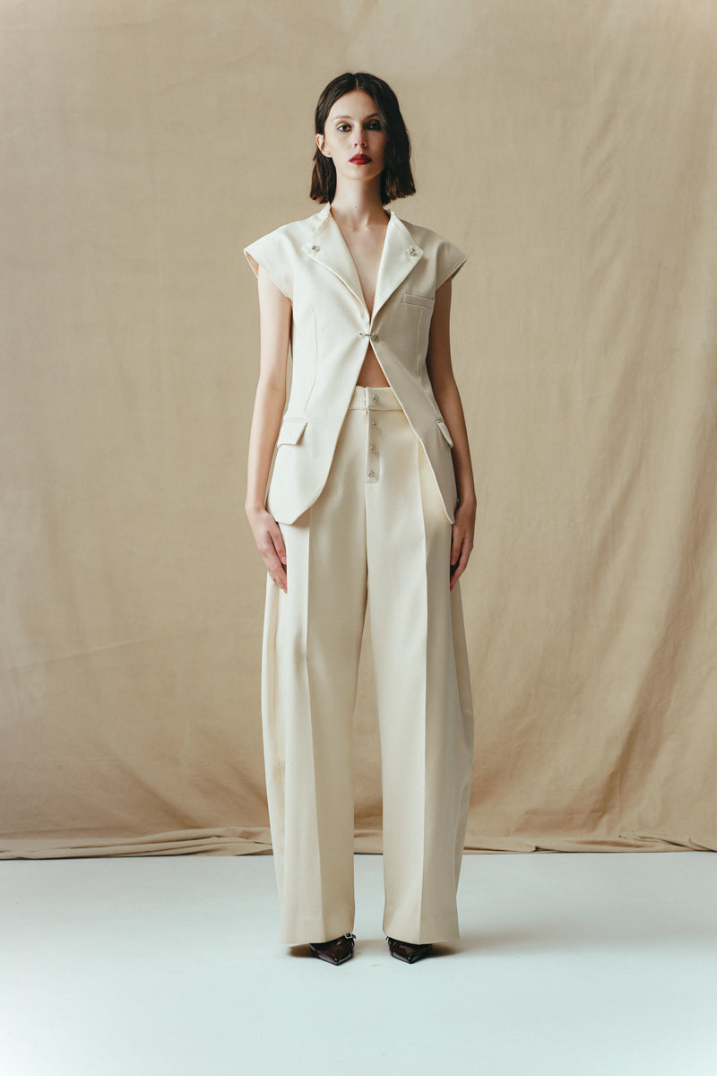 Sean Sheila eggshell vest with a single hook closure, front view of the stylish sleeveless top.