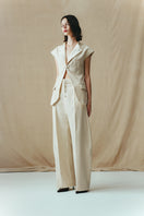 Eggshell vest with single hook detail from Sean Sheila, stylish sleeveless top shown from side view.