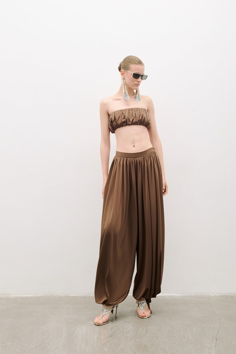 AWAVE draped harem pants with ruched detail paired with a strapless top, styled as a trendy co-ord set in a fashion-forward look.