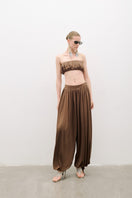 AWAVE draped harem pants with ruched detail paired with a strapless top, styled as a trendy co-ord set in a fashion-forward look.
