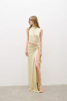 Butter yellow AWAVE maxi dress with cut-out detailing and a flowing silhouette, shown on a model.