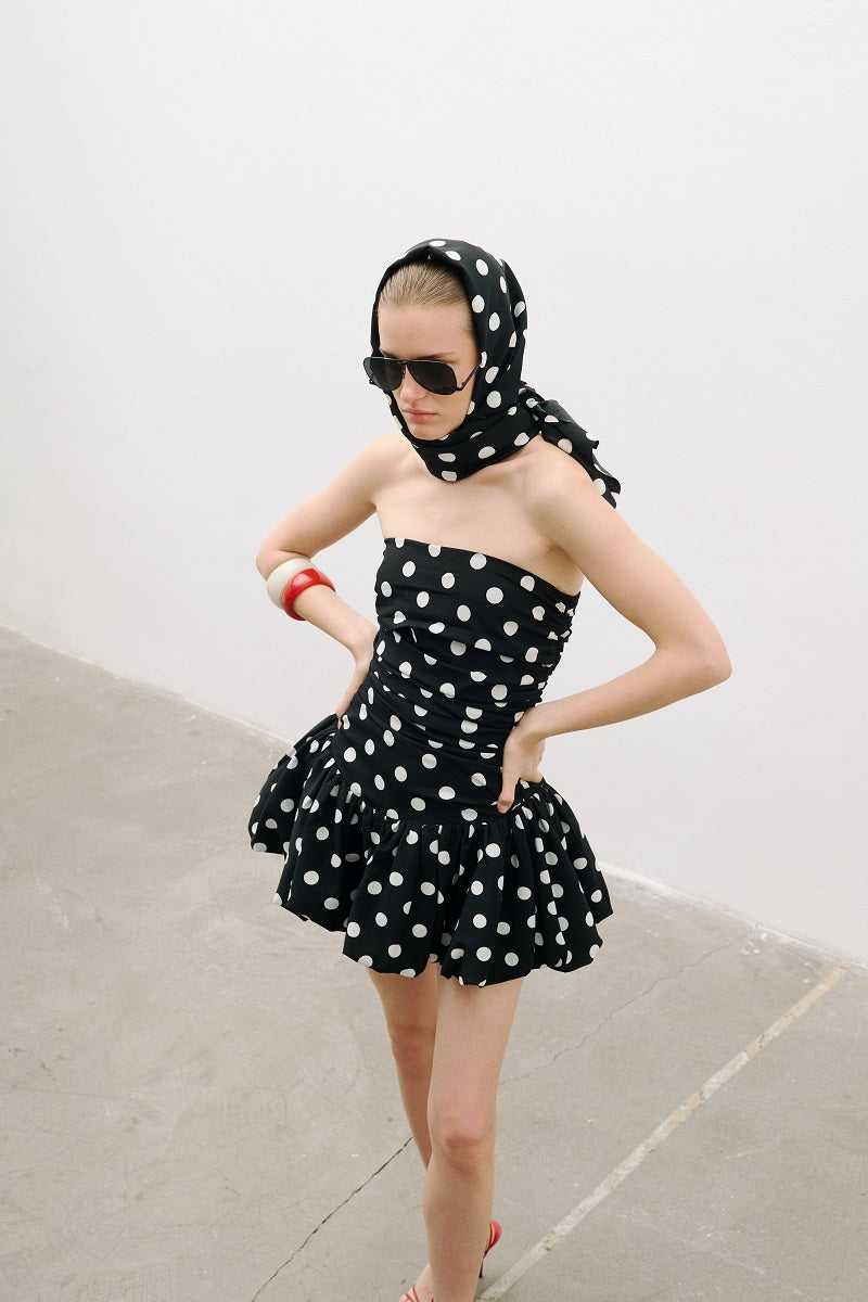 AWAVE ruched strapless mini dress with a balloon skirt, featuring a fitted bodice and playful, voluminous skirt design.