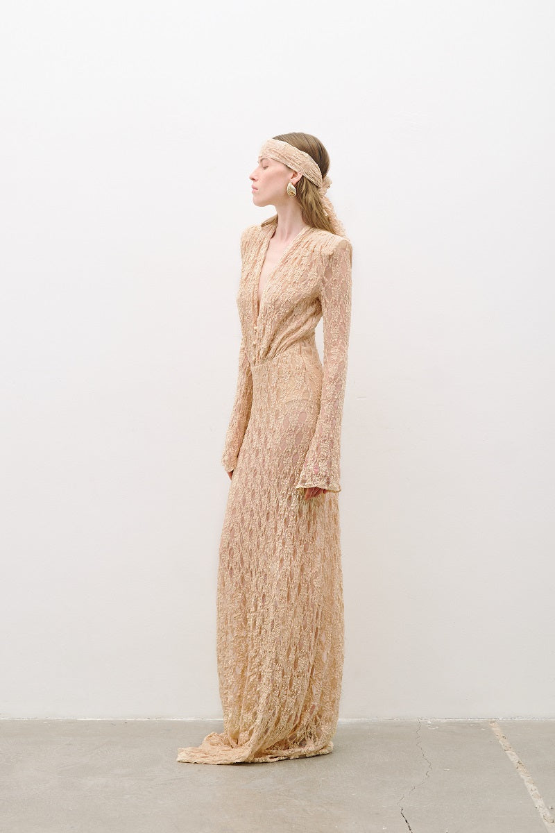 Light pink salmon long-sleeved maxi dress by AWAVE, flowing fabric, elegant design, showcased on a model.
