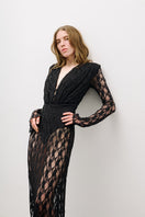 Black long-sleeved maxi dress by AWAVE, flowing fabric, fitted waist, and elegant design, shown on a model.