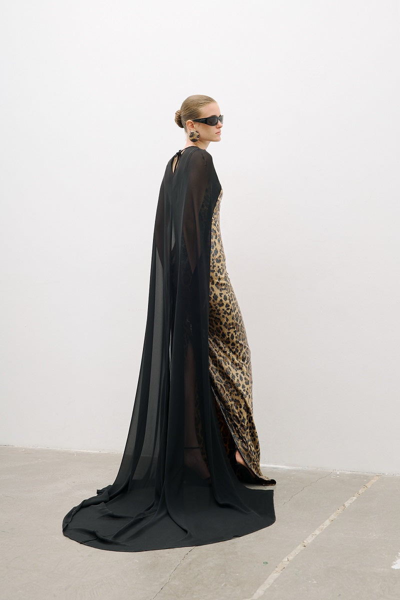 AWAVE leopard print maxi gown with thin straps featuring a detailed cape design, elegant and flowing for formal occasions.