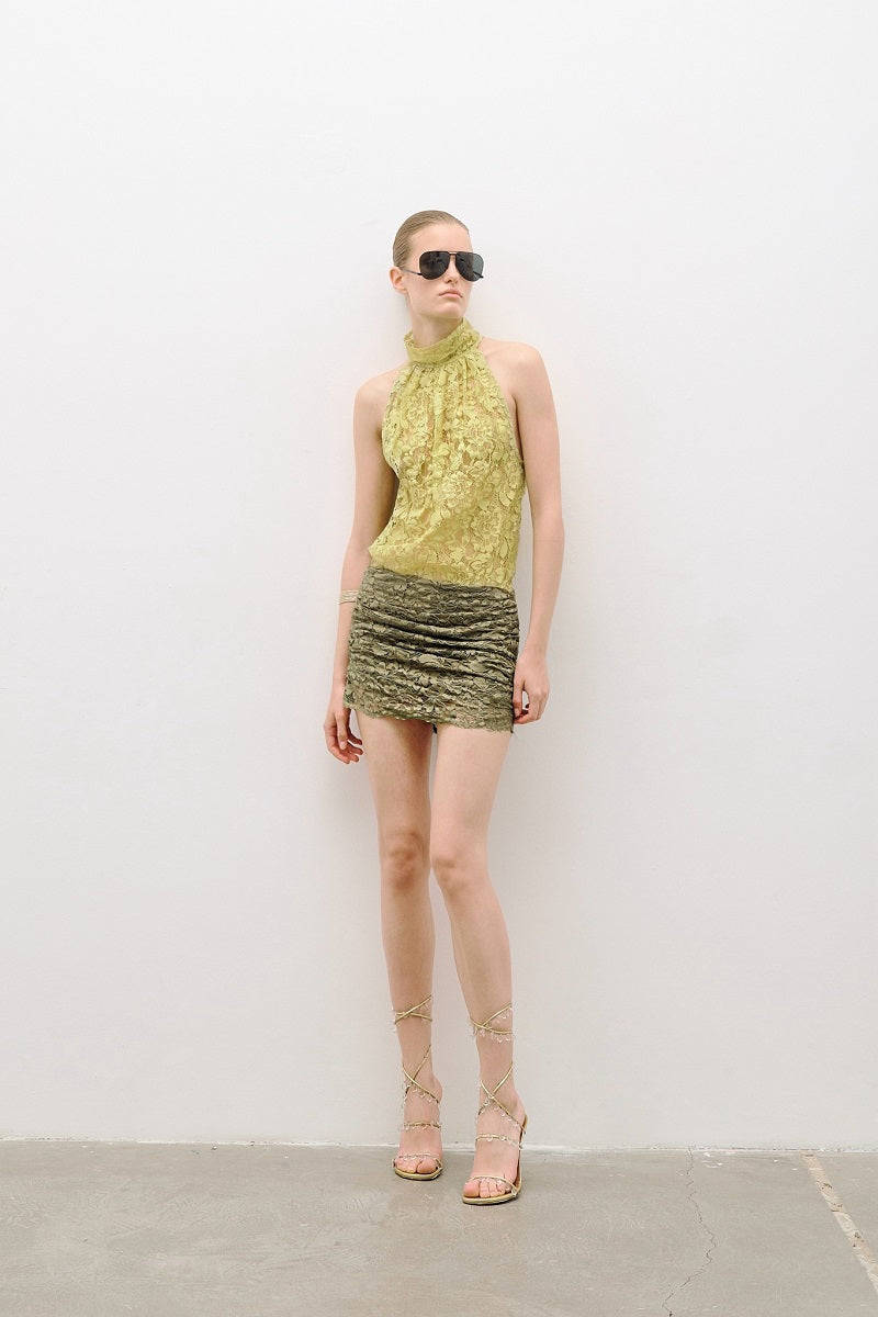 AWAVE turtleneck bodysuit with draped mini skirt, stylish and form-fitting, shown in a close-up fashion shot.