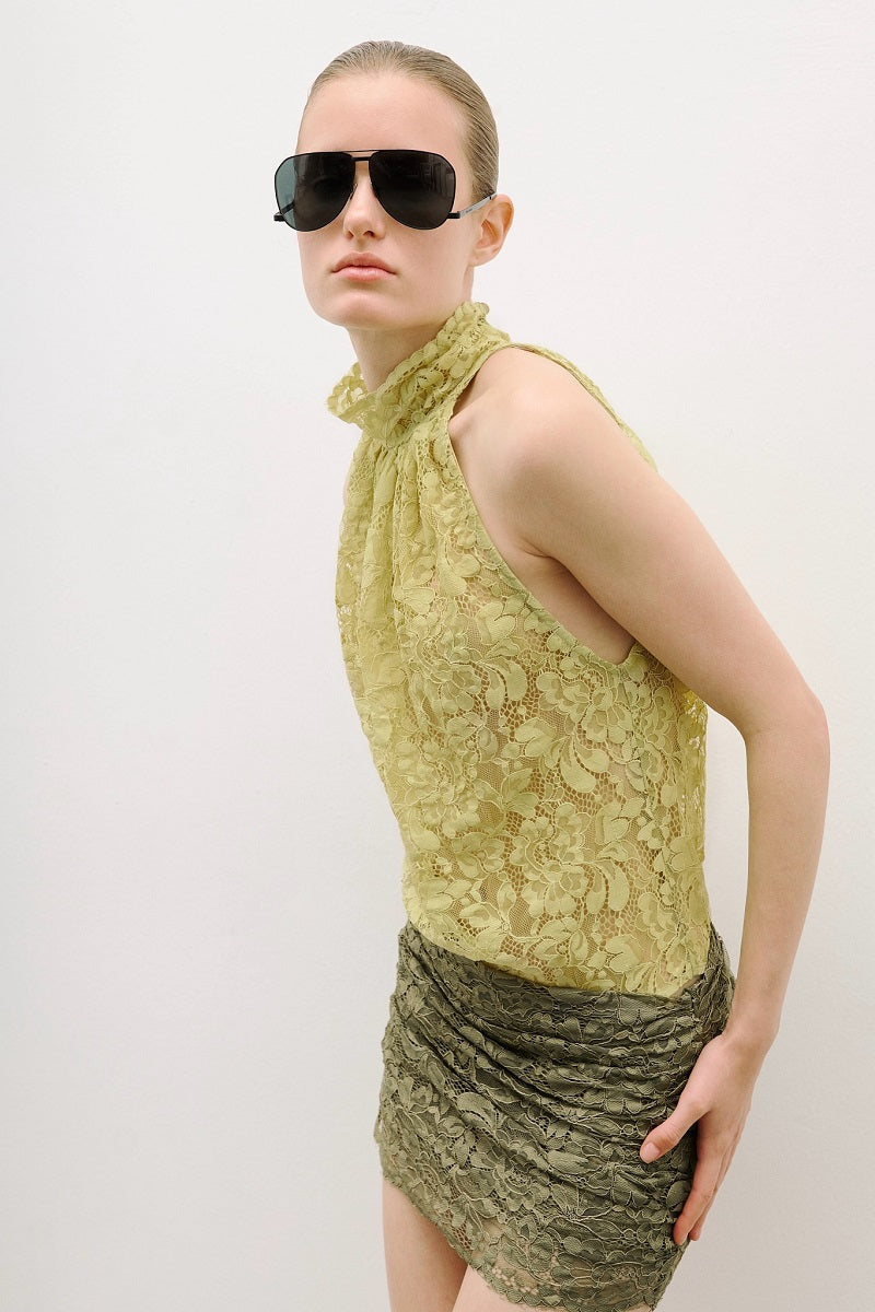 AWAVE turtleneck bodysuit with draped detail paired with a mini skirt, stylish and form-fitting fashion ensemble.