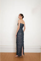 Back view of YASSMIN SALEH fade teal maxi gown with flowing fabric and elegant design.
