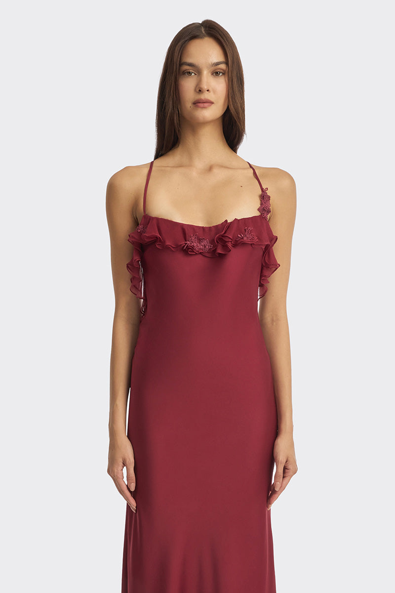 Elegant burgundy fairy ruffle maxi dress by Stolen Stores, featuring flowing fabric and delicate ruffle details.
