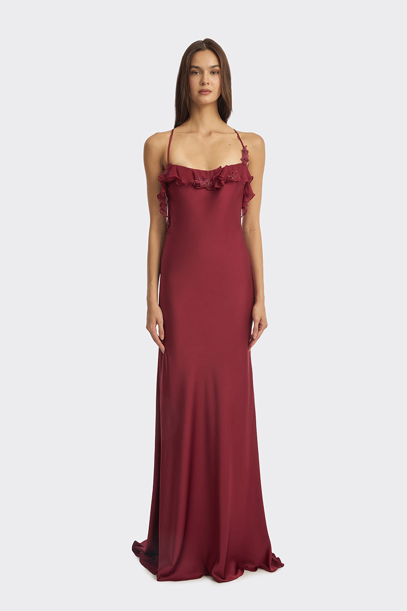 Elegant burgundy fairy ruffle maxi dress by Stolen Stores, featuring flowing fabric and intricate ruffle details.