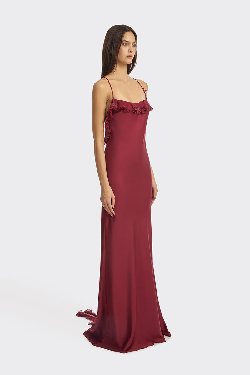 Burgundy fairy ruffle maxi dress by Stolen Stores featuring flowing fabric and ruffle details, perfect for elegant occasions.