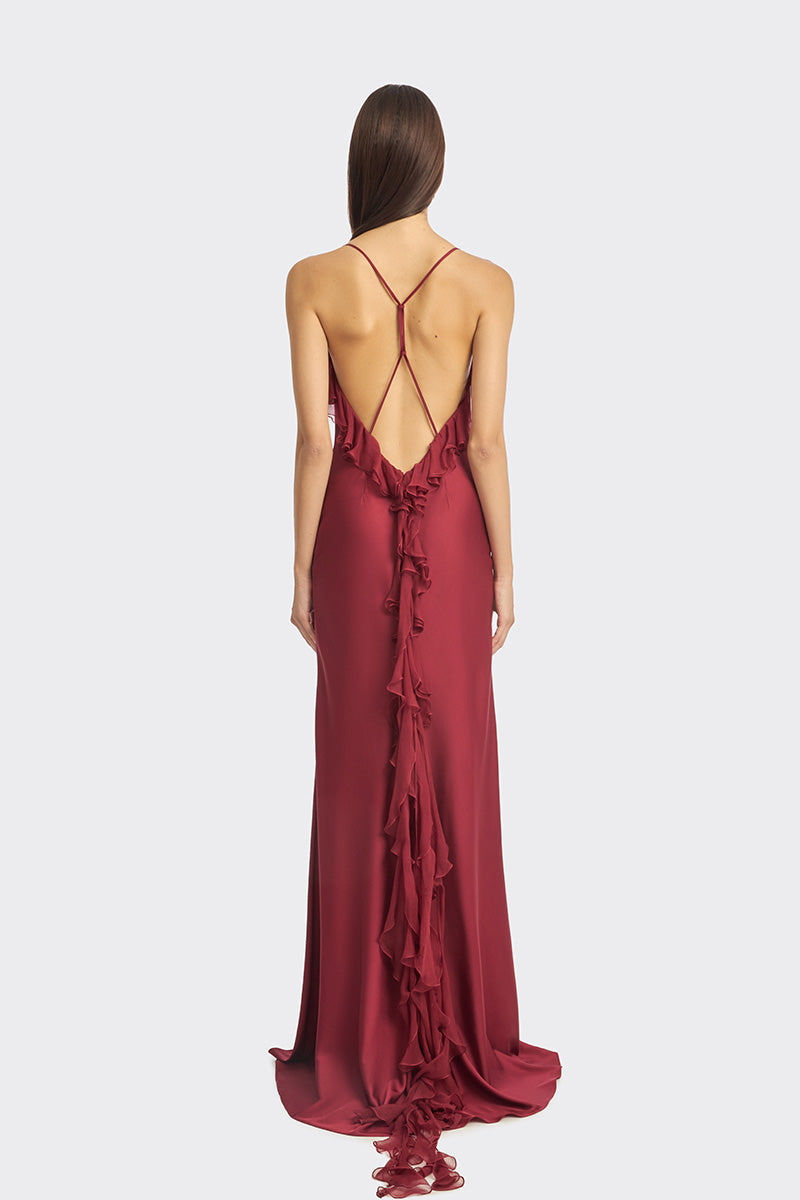 Burgundy fairy ruffle maxi gown by Stolen Stores featuring flowing fabric and elegant ruffle details.