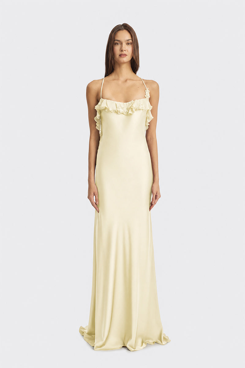 Light yellow fairy ruffle maxi dress by Stolen Stores featuring flowing fabric and delicate ruffle details.