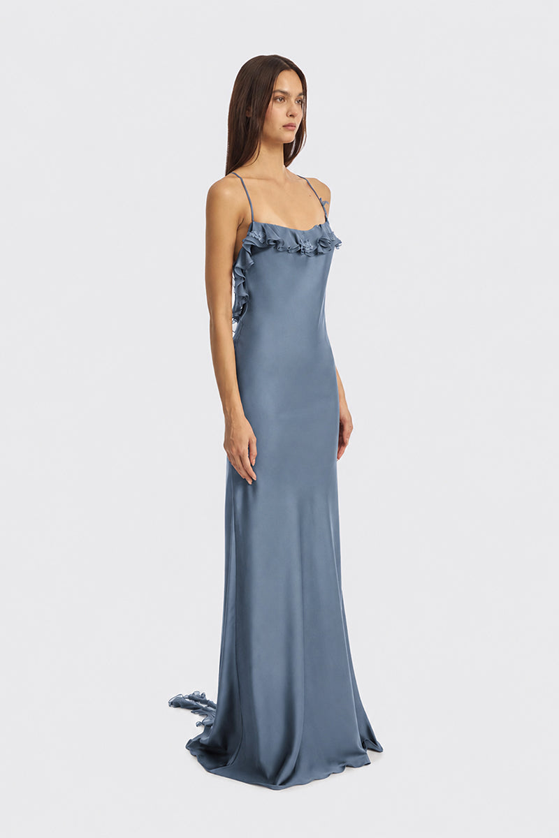 Dusty blue Fairy Ruffle Maxi Dress by Stolen Stores featuring floral ruffles and flowing fabric, perfect for elegant occasions.