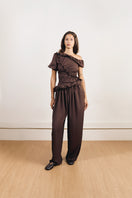 YASSMIN SALEH falling brown pants displayed from the front, showcasing the stylish, relaxed fit and fabric texture.