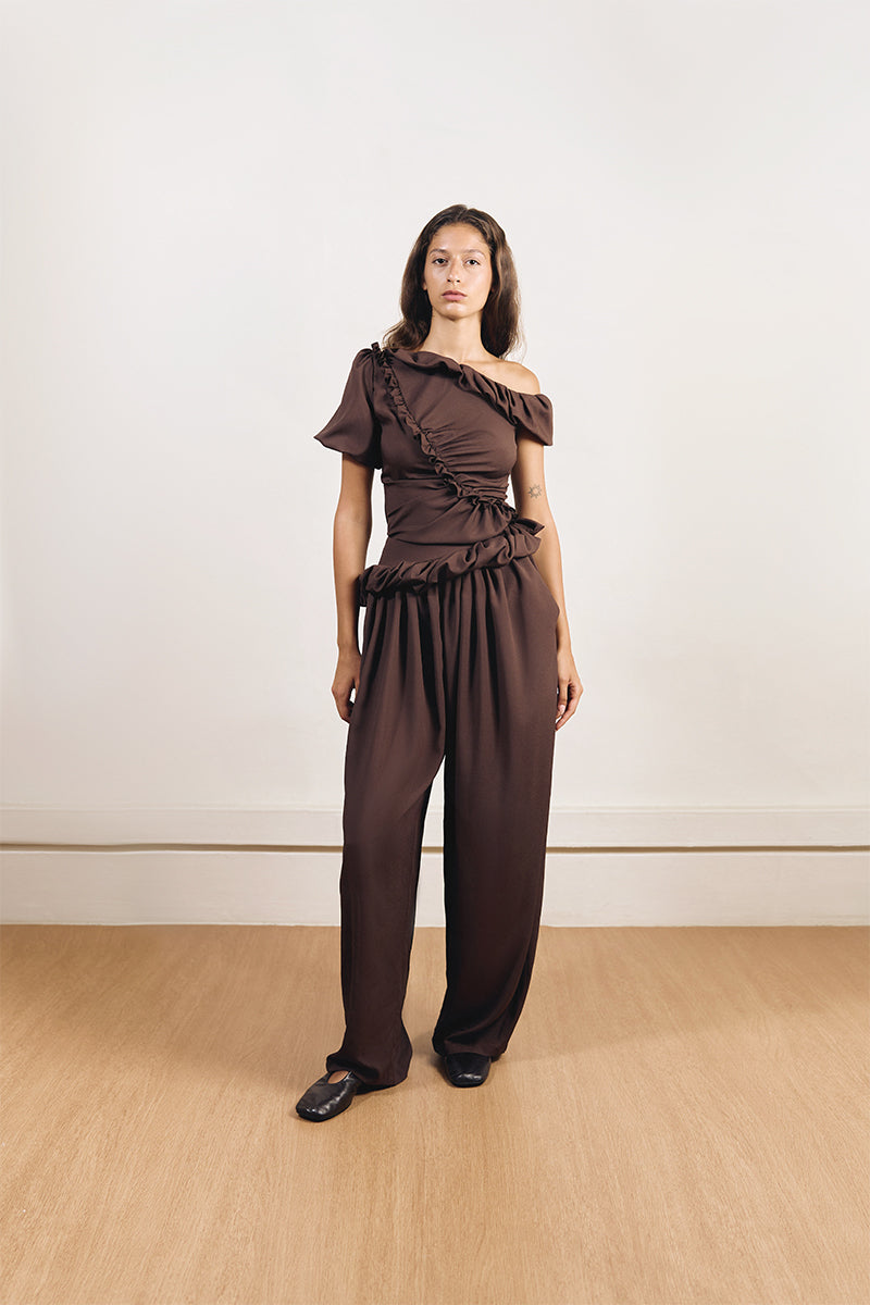YASSMIN SALEH falling brown pants displayed from the front, showcasing the stylish, relaxed fit and fabric texture.