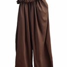 YASSMIN SALEH falling brown pants with a relaxed fit and stylish design, shown hanging against a white background.
