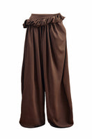 YASSMIN SALEH falling brown pants with a relaxed fit and stylish design, shown hanging against a white background.