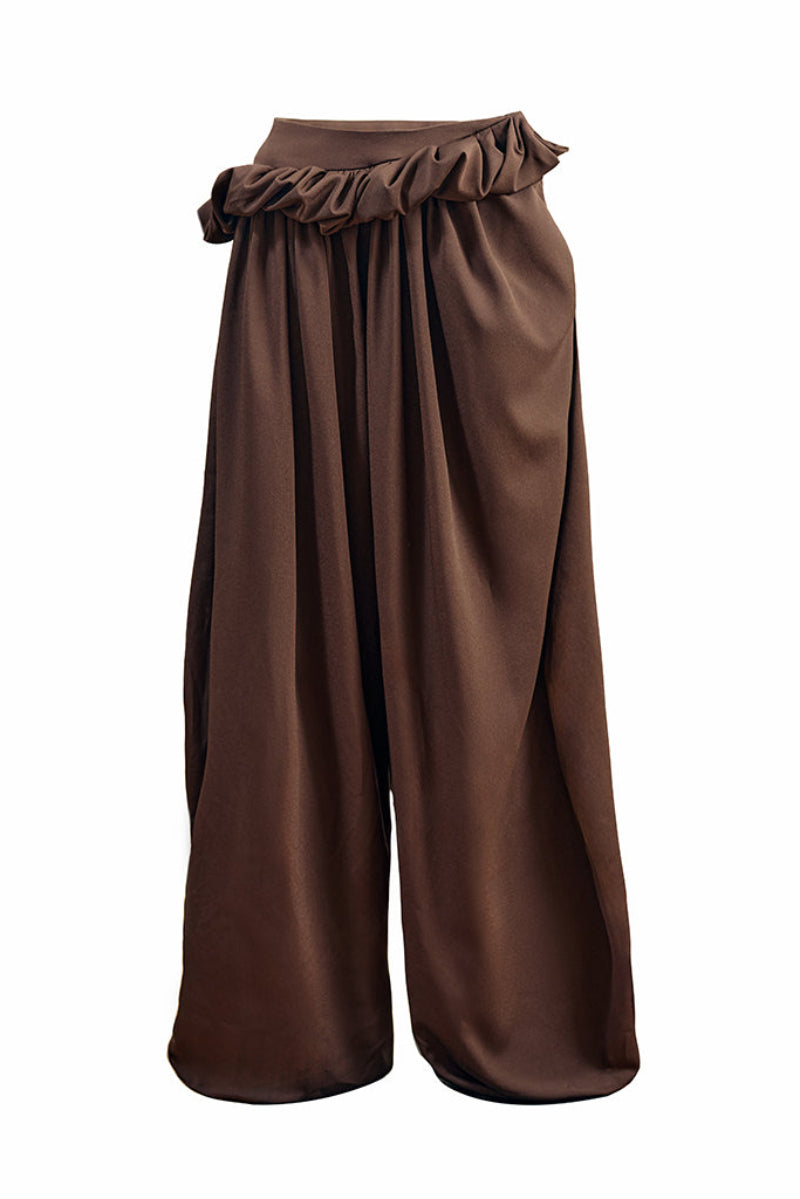 YASSMIN SALEH falling brown pants with a relaxed fit and stylish design, shown hanging against a white background.