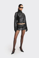 Black faux leather racing belt jacket from Stolen Stores featuring a stylish, fitted design with belt details and racing-inspired style.