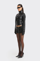 Black faux leather racing belt jacket from Stolen Stores, featuring a stylish design with belt accents and a sleek, fitted silhouette.