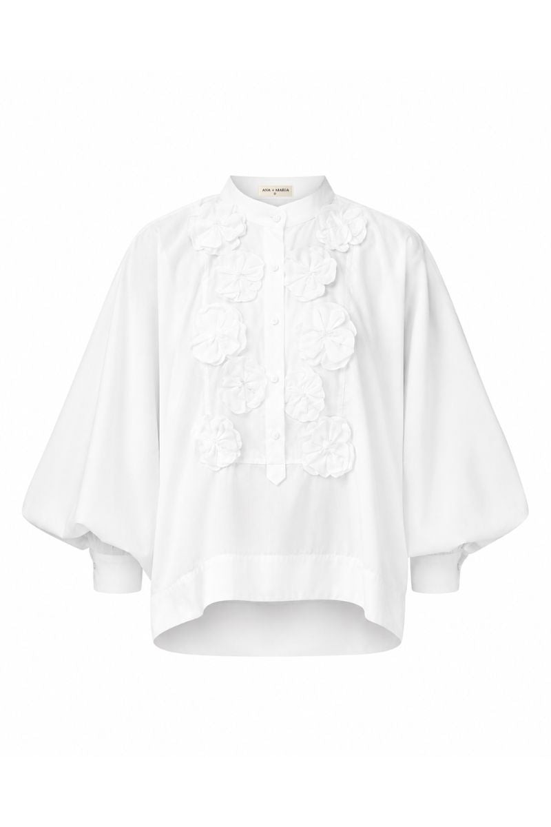 White FIORA top by ANA + MARIA displayed on a ghost mannequin, showcasing its stylish design and fabric details.