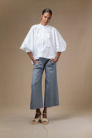 White FIORA top by ANA + MARIA, featuring a stylish design, displayed on a neutral background.