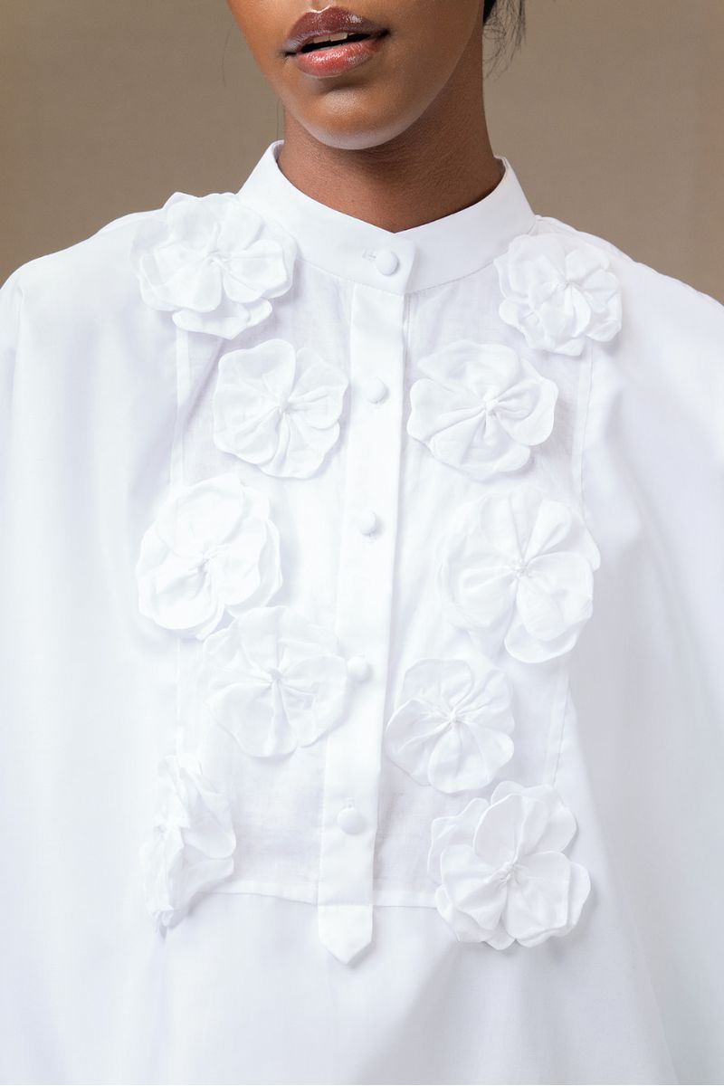 White Ana + Maria Fiora top, showcasing a stylish sleeveless design with a fitted silhouette.