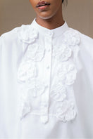 White FIORA top by ANA + MARIA, showcasing a stylish sleeveless blouse with a relaxed fit and elegant design.