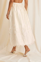 Scarlett Gasque Fiorella maxi skirt in cloud dancer color, back view showcasing flowing fabric and elegant design.