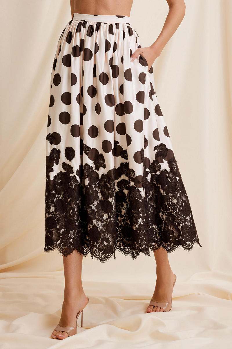 Scarlett Gasque Fiorella dot midi skirt featuring a flowy fabric and a stylish pattern, shown from the front.