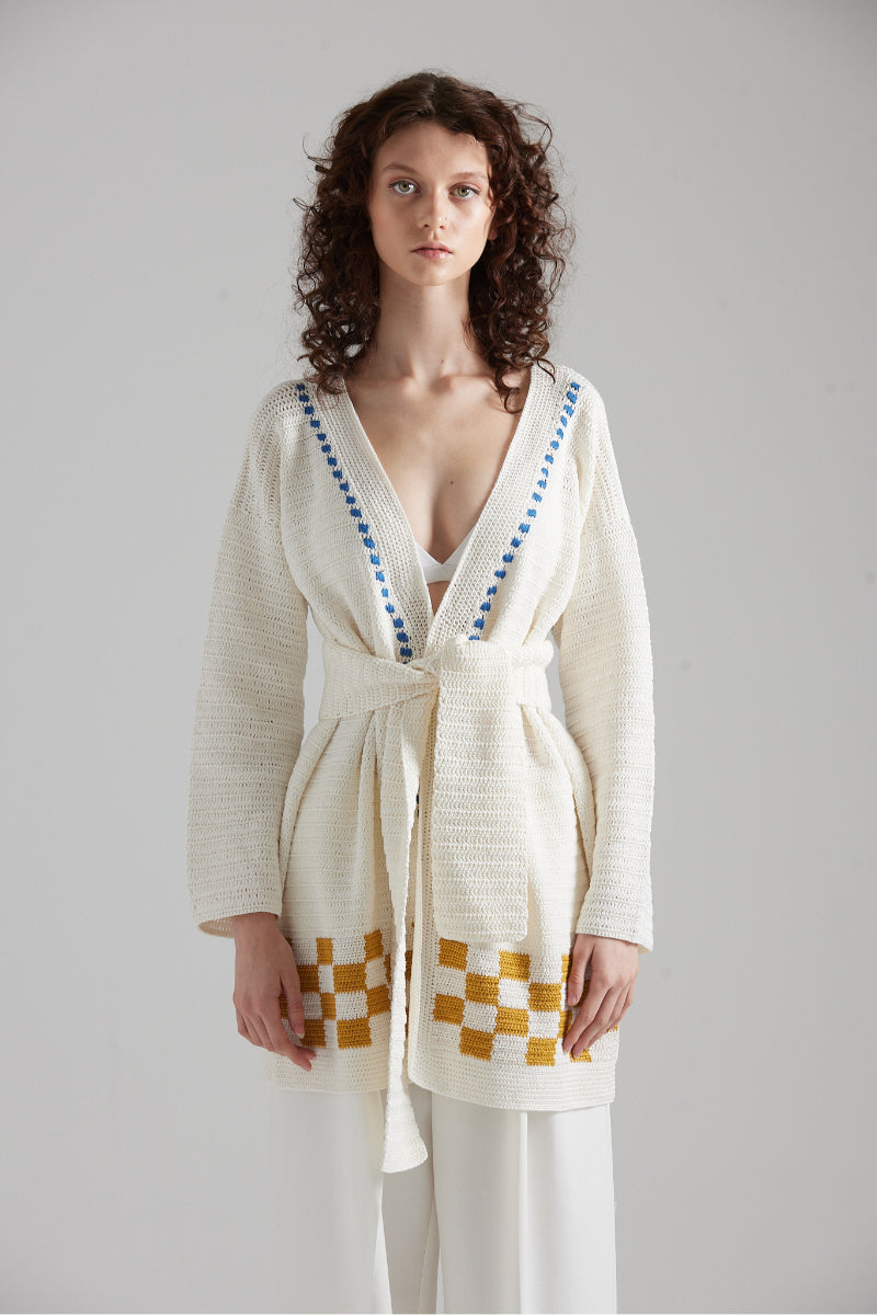 First Born Knits LA PALME cardigan featuring a cozy, stylish design with textured knit fabric and button closure.