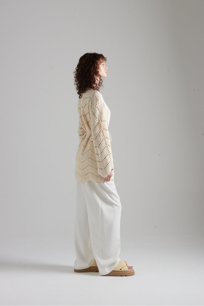 First Born Knits MIA cardigan in soft knit fabric, featuring a cozy fit and stylish design, worn by a model.
