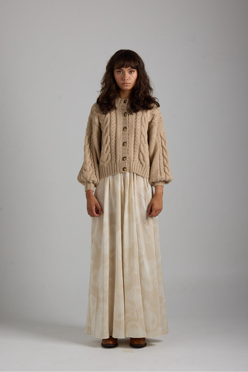 Cream-colored LULU cardigan by First Born Knits, featuring a cozy knit texture and button-up front, perfect for casual wear.