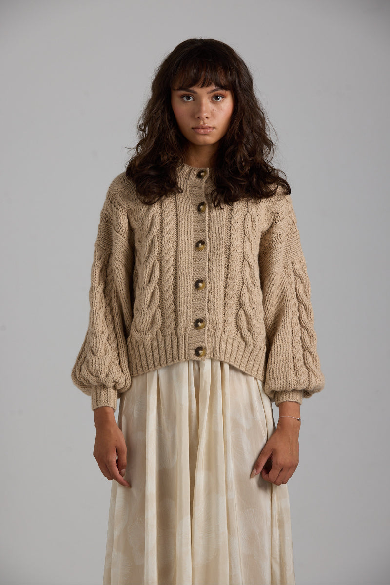 Light grey First Born Knits Lulu cardigan with button closure, featuring a soft knit fabric and classic design.