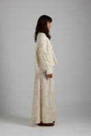Light gray Paris cardigan by First Born Knits, featuring a soft knit texture and classic button-up design.