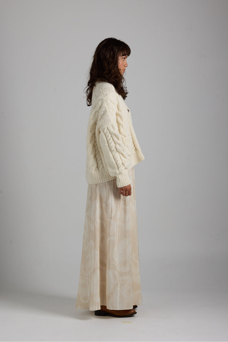 Light gray Paris cardigan by First Born Knits, featuring a soft knit texture and classic button-up design.