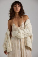 Gray Paris cardigan by First Born Knits featuring a cozy knit texture and a relaxed fit, displayed on a hanger.