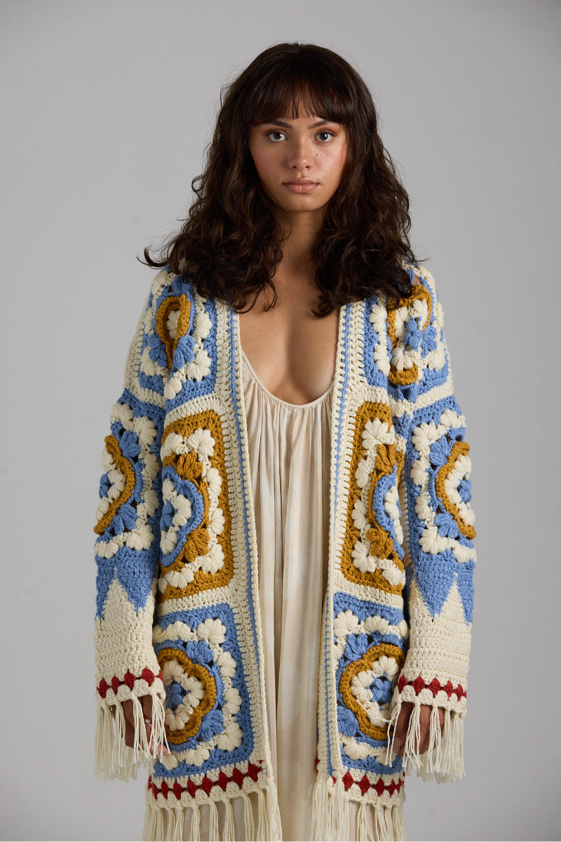 Cream-colored Sienna cardigan by First Born Knits, showing a cozy knitwear cardigan with front buttons and ribbed cuffs.
