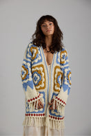 Light beige Sienna cardigan by First Born Knits, soft knitwear with a relaxed fit and button closure, displayed on a neutral background.