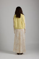 Cozy Tierra Vest from First Born Knits, a stylish knitwear piece featuring a textured design and neutral color.