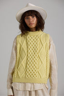 Gray Tierra Vest knitwear by First Born Knits featuring a cozy, textured design and ribbed neckline on a mannequin.